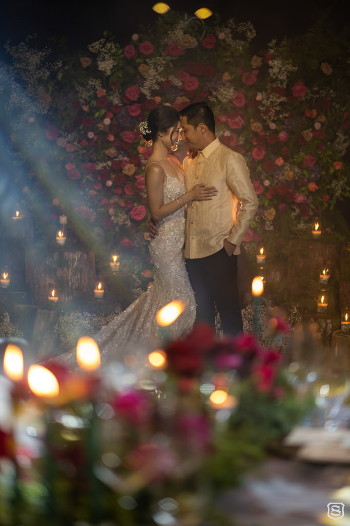 Karlo & Nica on their floral wall by Khim Cruz