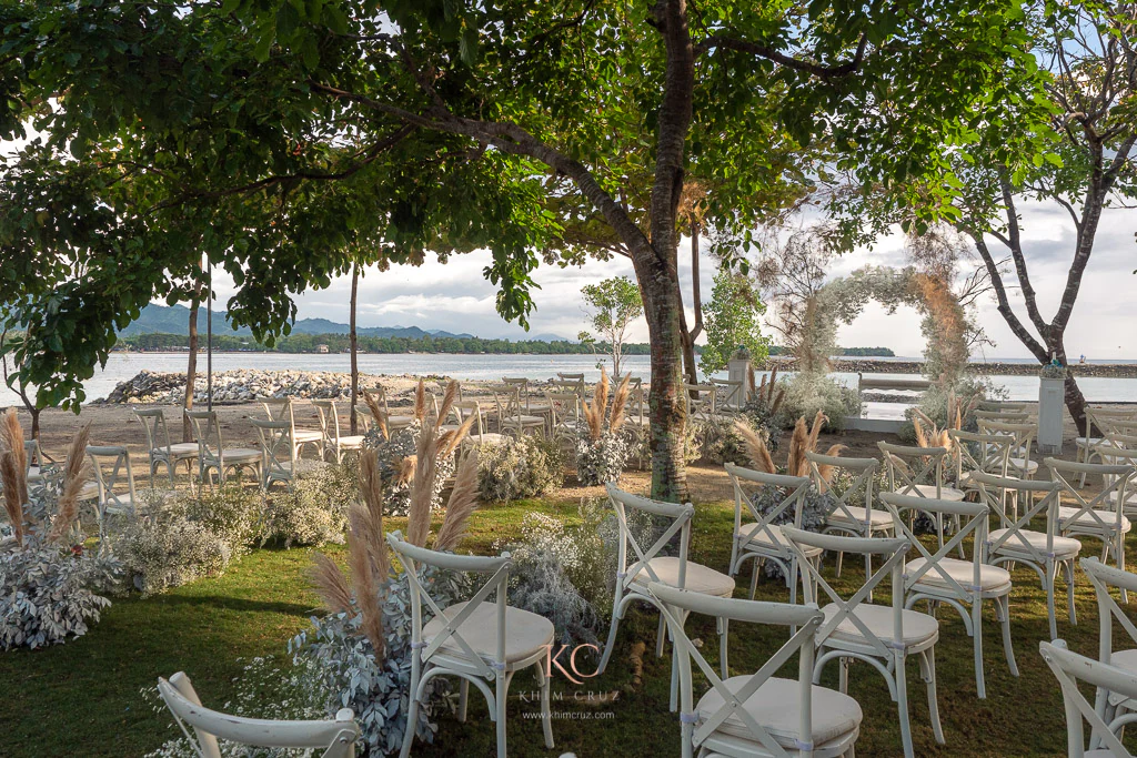 Boho wedding ceremony by the beach of Neil and Mieko with Gypsophila aisle and arch made by Khim Cruz