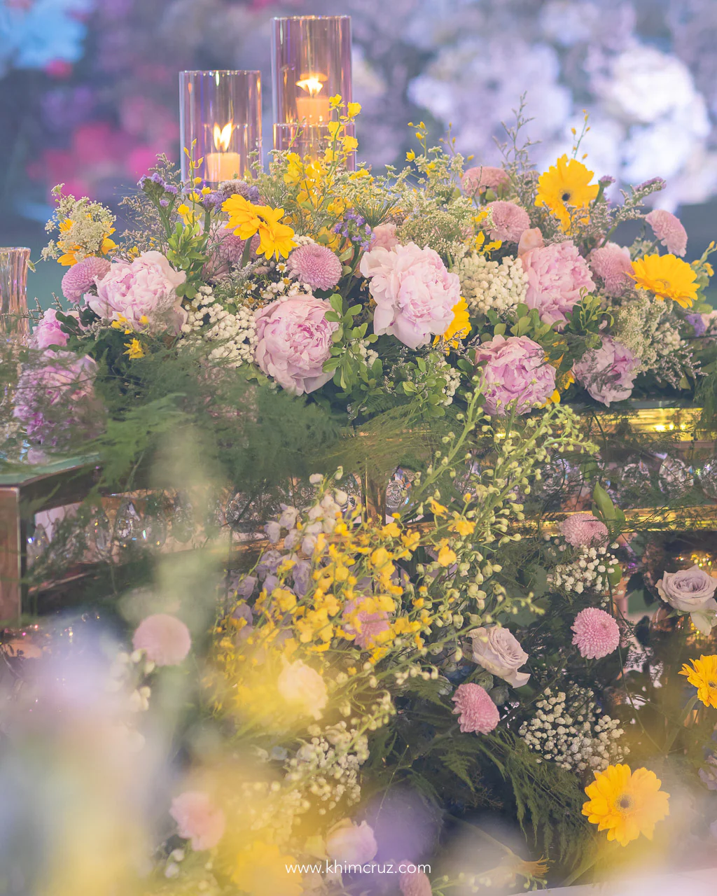 Abundant peonies adorn the floral table arrangements at this spring garden-inspired wedding reception