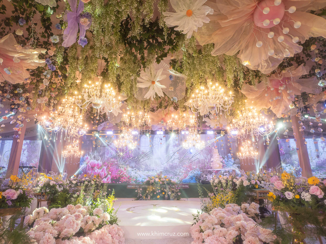 Dreamy spring garden-inspired wedding with chandeliers cascading blooms and a dance floor surrounded by florals