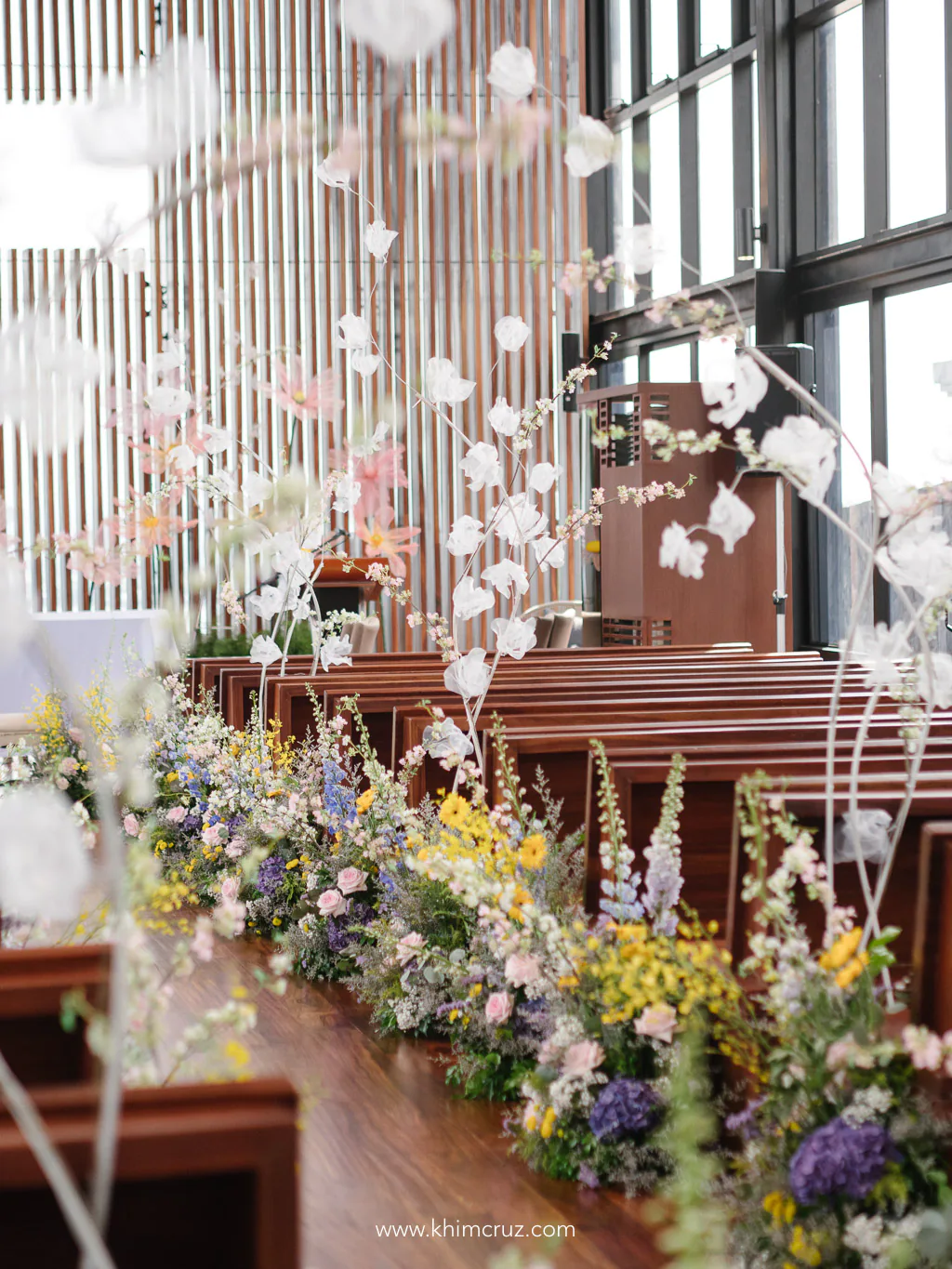 vibrant spring colors adorn the wedding ceremony aisle