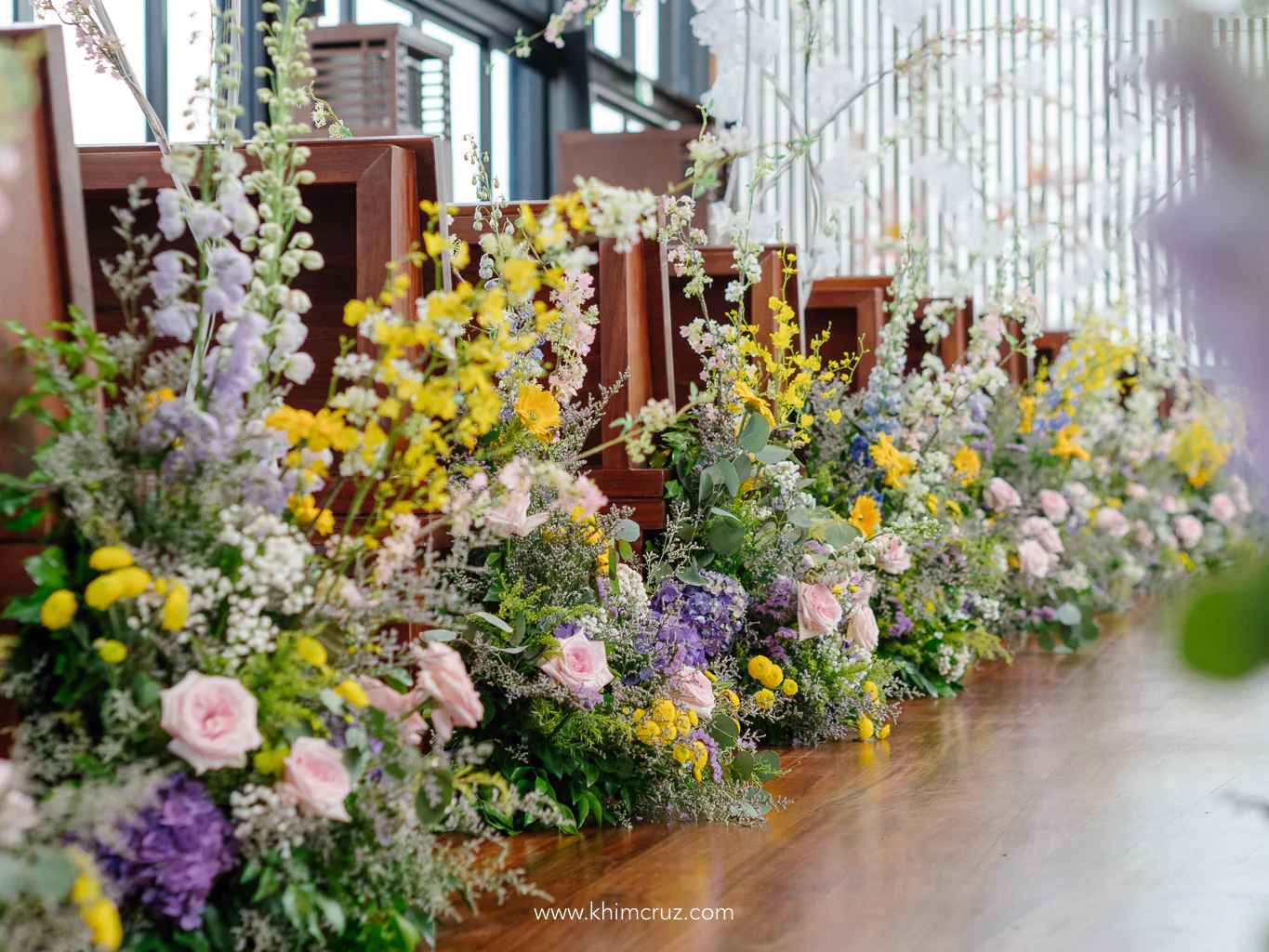 wedding ceremony aisle adorned in vibrant spring hues