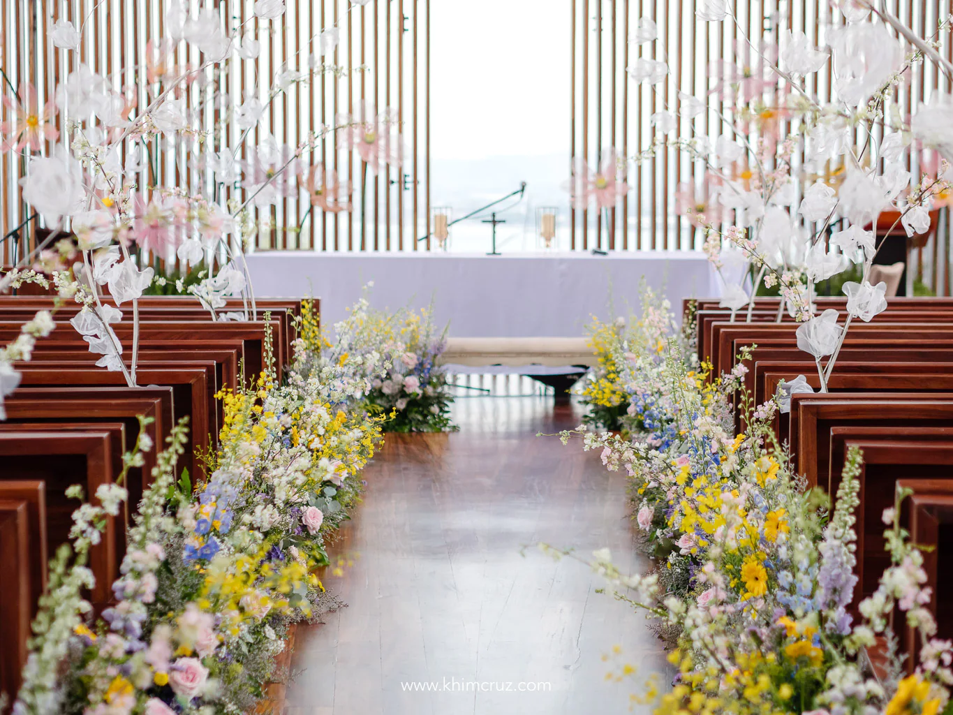 wedding ceremony aisle gleams with radiant spring colors