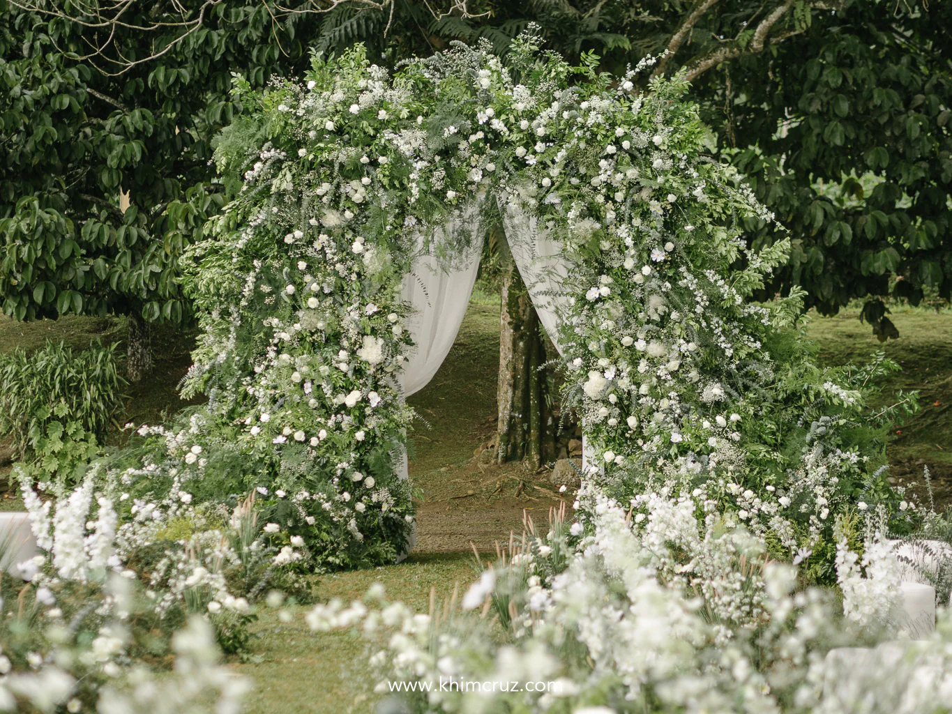 elegant unstructured and beautifully intertwined wedding ceremony entrance floral arch