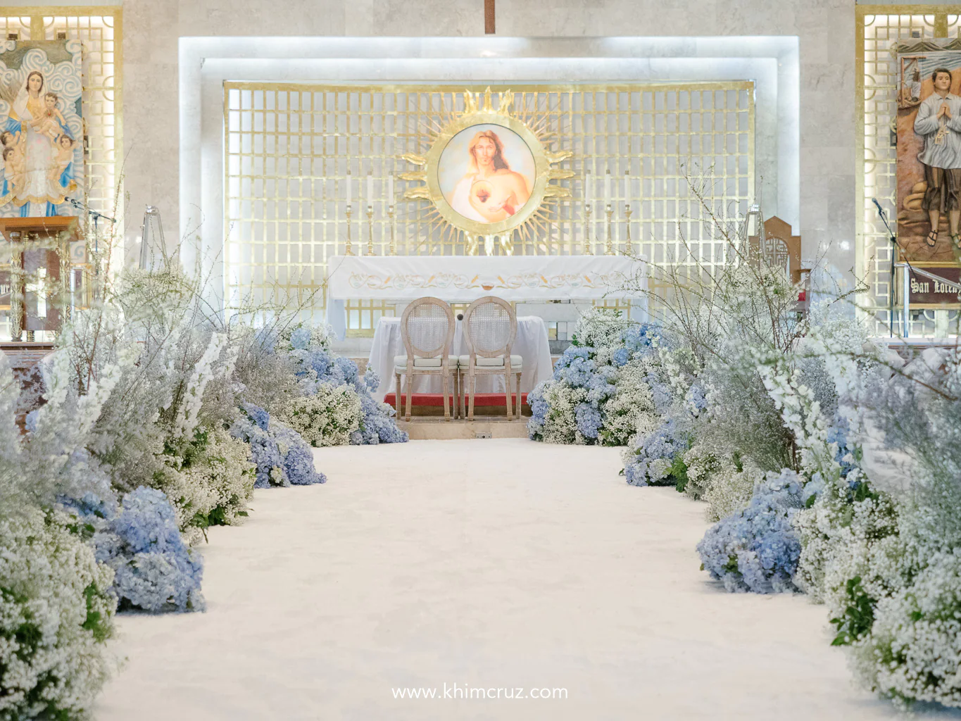 babys breath flowers in front of altar flower garlands lined both sides of aisle