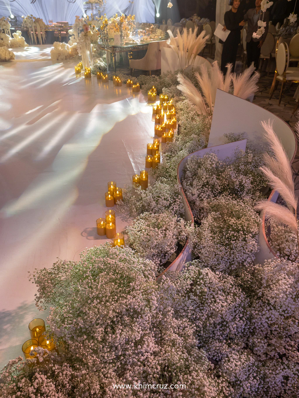 babys breath traces the graceful curves of the wedding pathway