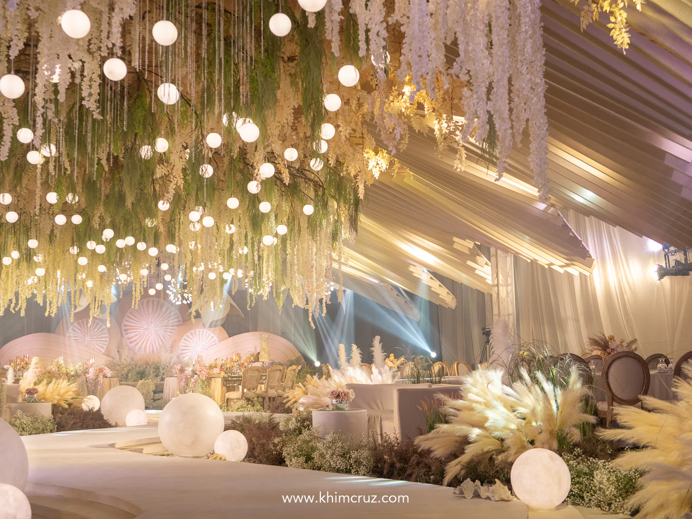 ceiling glows with pearl and shell-inspired ridges in this earthy seaside theme wedding