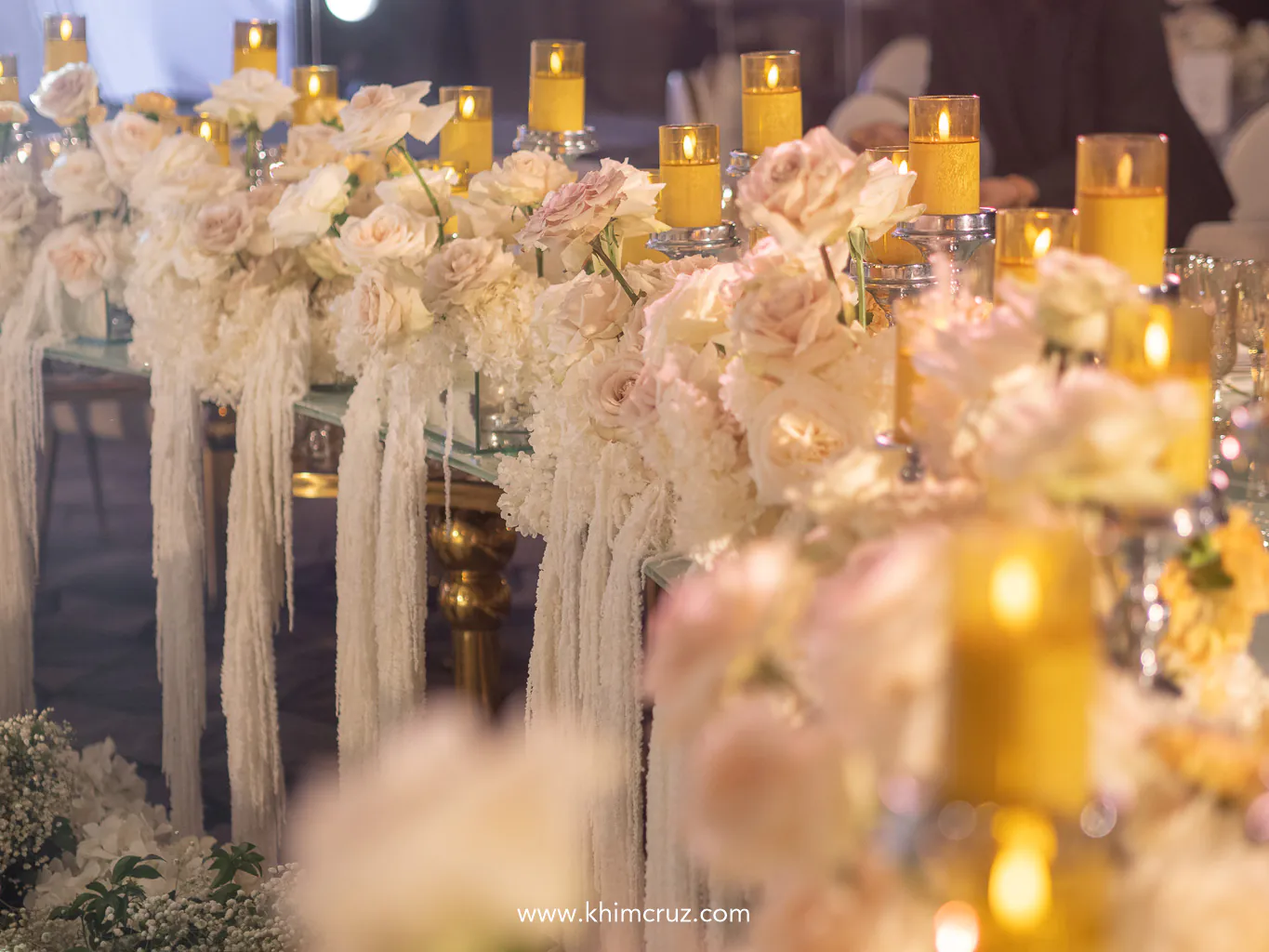 table decorated with white roses candles creating an elegant atmosphere for the wedding