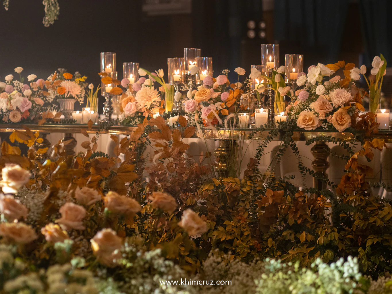 tables are elegantly decorated with a blend of pastel and warm-toned florals