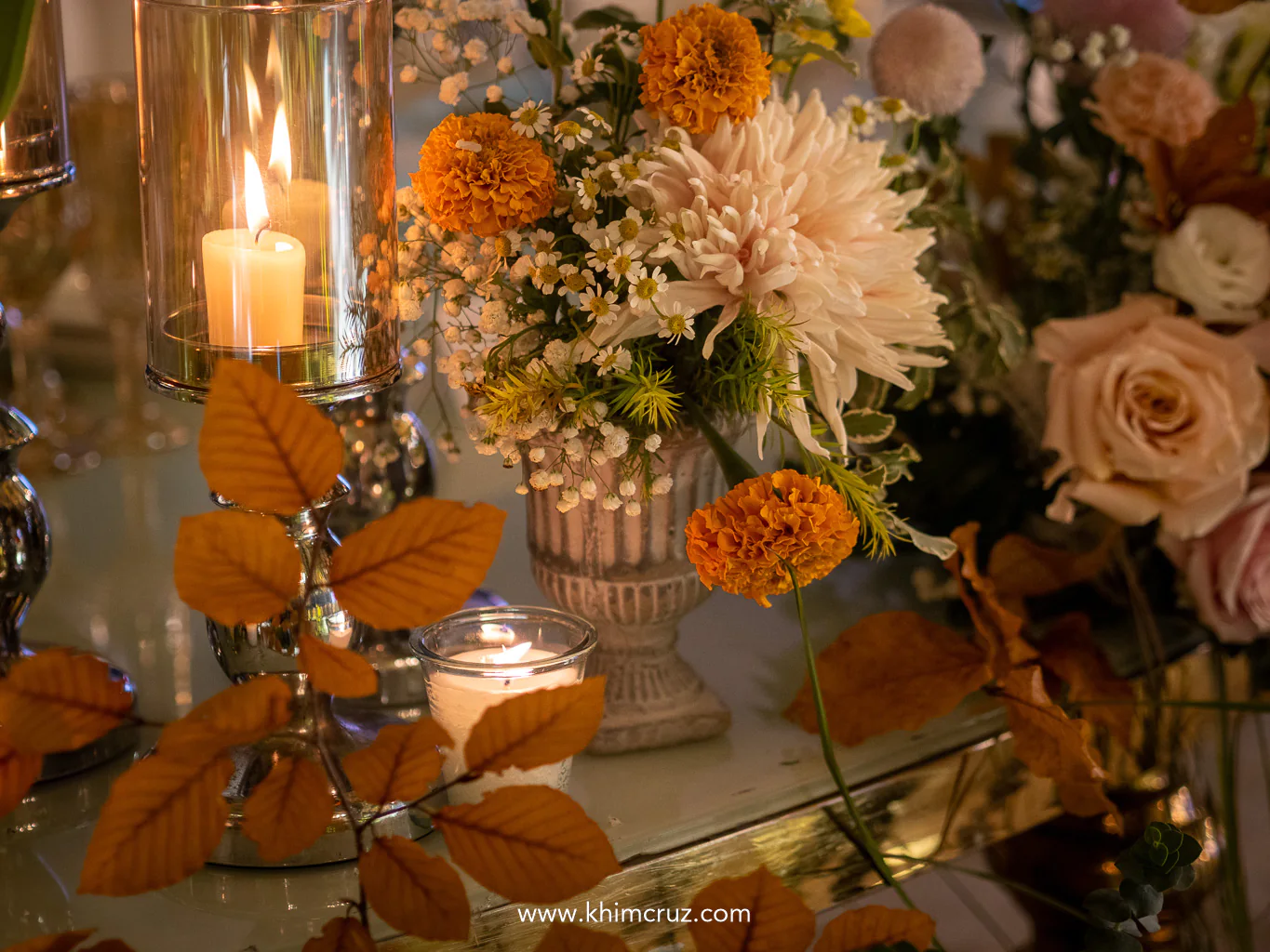 tables beautifully accented with potted blooms complemented by a mix of pastel and warm-toned florals