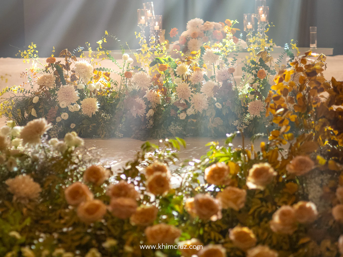 wedding dance floor framed by a blend of autumn and spring florals