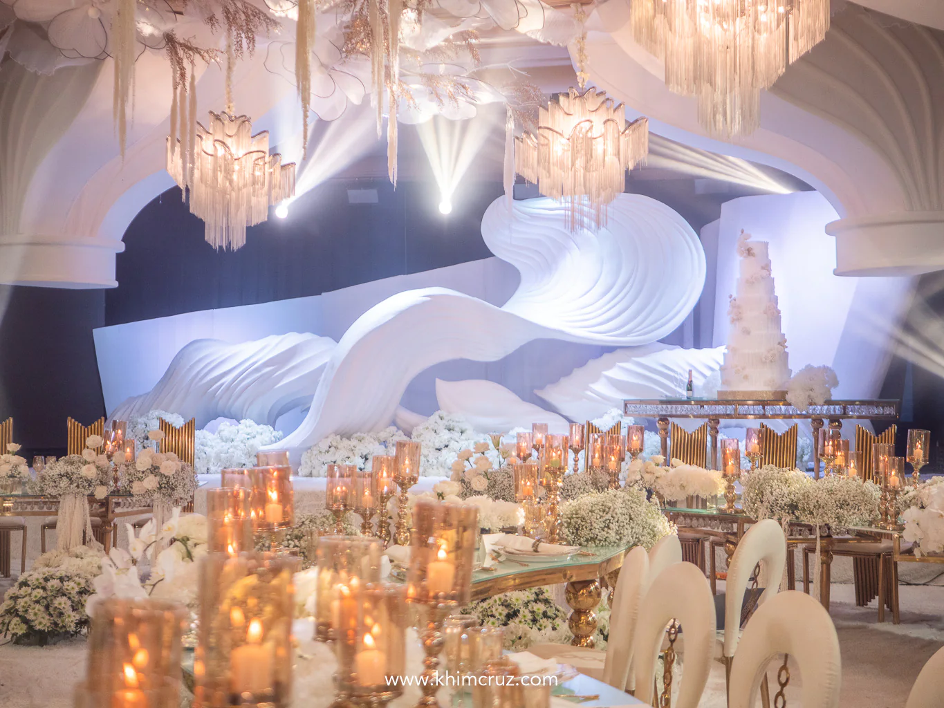 a grand wave-like art structure serves as the stage backdrop embodying fluidity and sophistication to the wedding reception