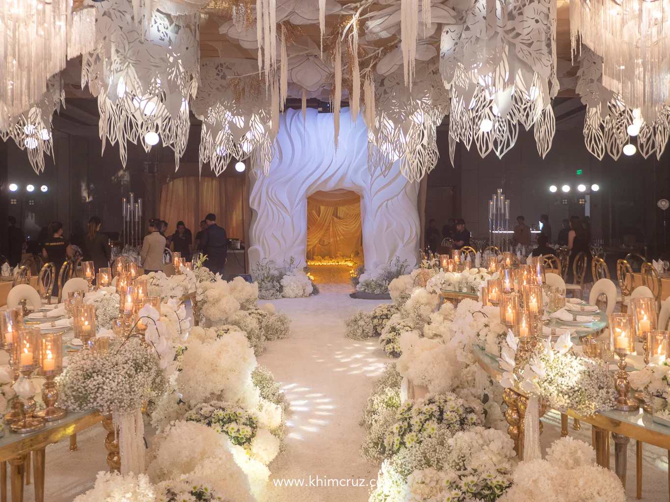 cascading florals and arching ceiling structures create a refined elegance to this wedding reception