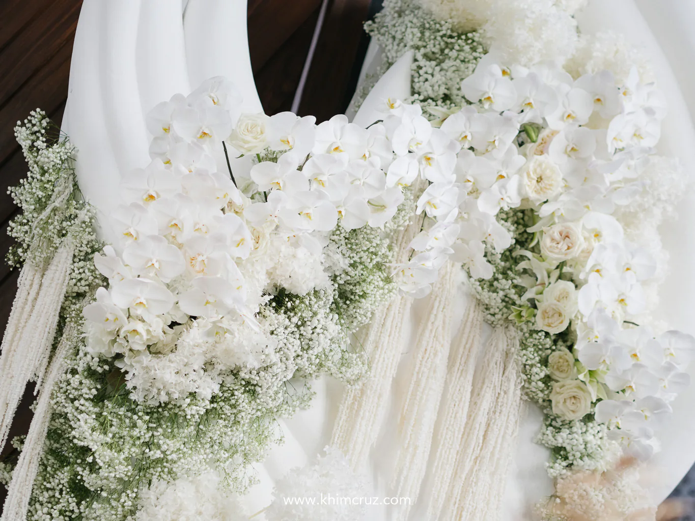 floral arch with a bold twist draped in lush white blooms