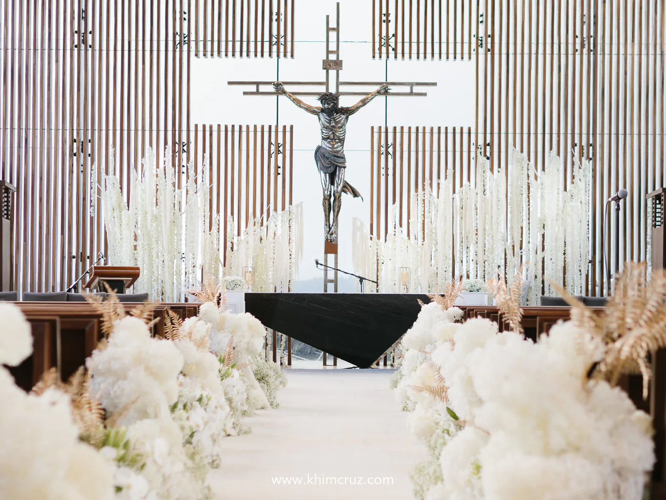 wedding ceremony aisle elegantly lined with cascading blooms